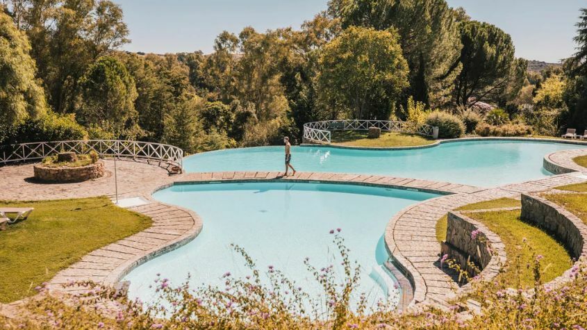 Homem a caminhar pela piscina do Hotel Fonte Santa